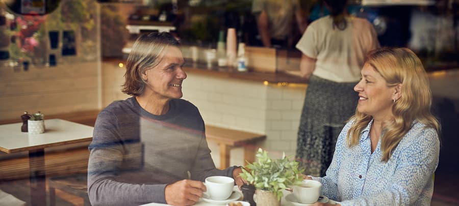 Man and a women sitting in a coffee shop having a drink