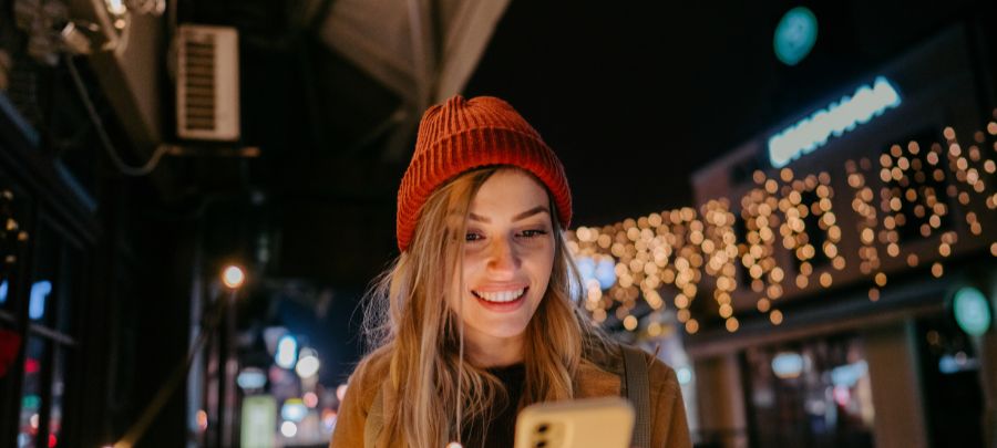Smiling woman looking at her phone.