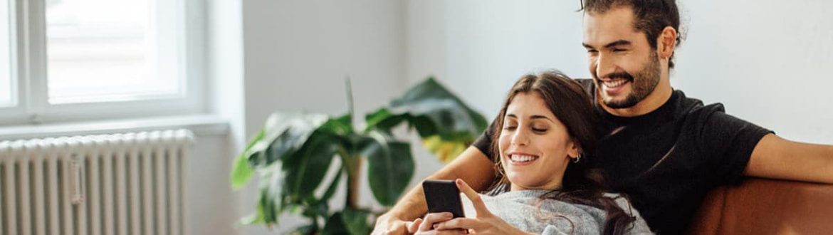 Couple smiling at phone
