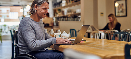 Man in a cafe using a laptop