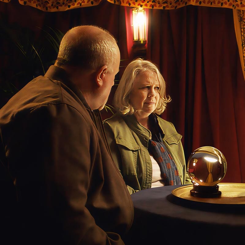 Couple sat looking at a crystal ball