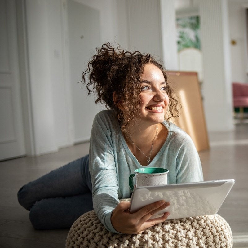 Woman smiling on tablet.