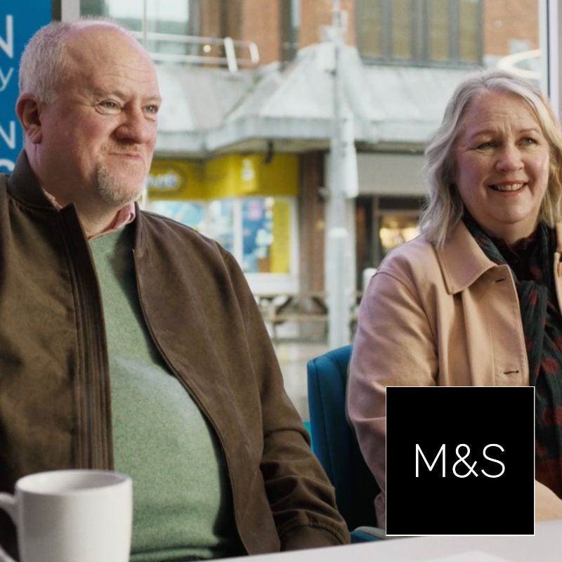 A man and a woman sat in a Skipton Building Society branch