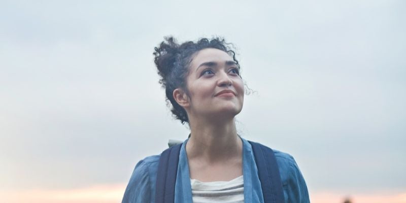 Woman smiling outdoors.