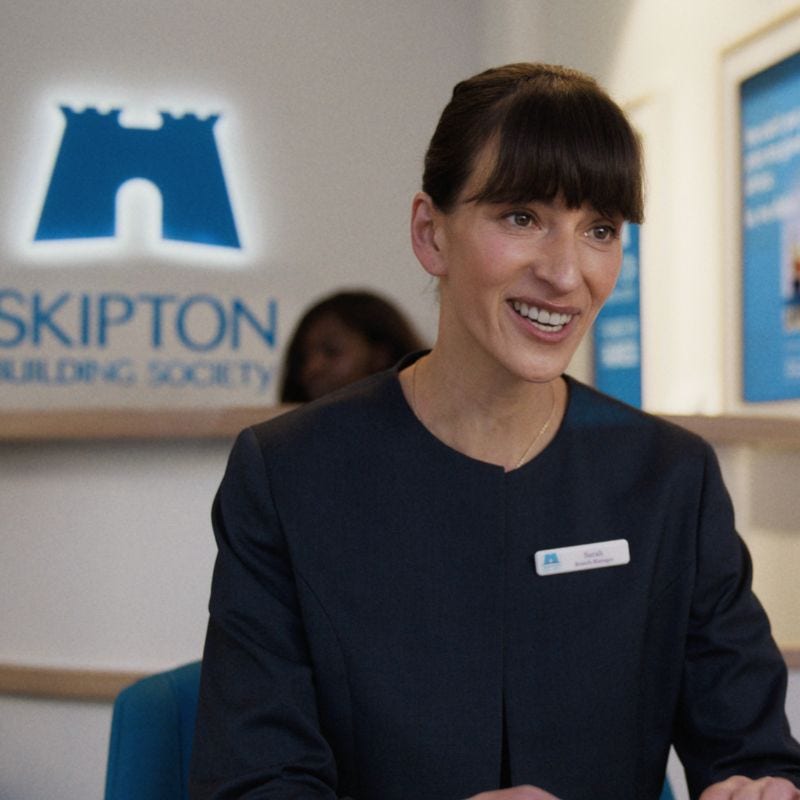 Female Skipton branch staff member smiling warmly