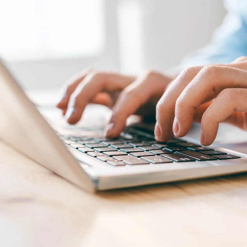 Typing on a laptop