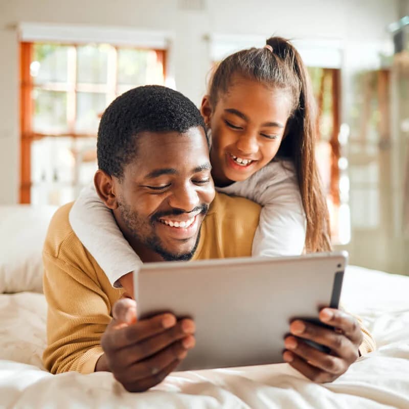 Father and daughter watching a tablet