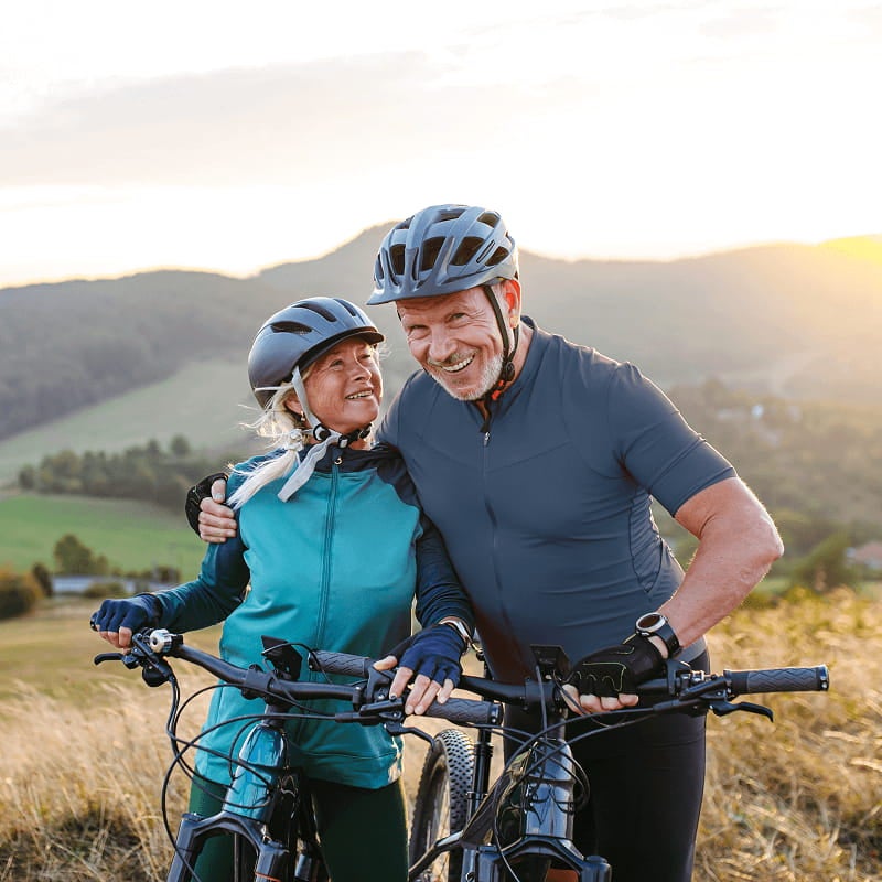 Couple riding bicycles outdoors