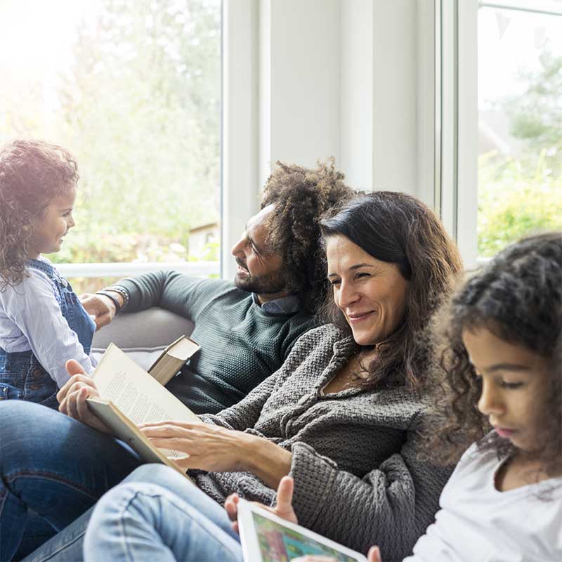 Family sat together reading 